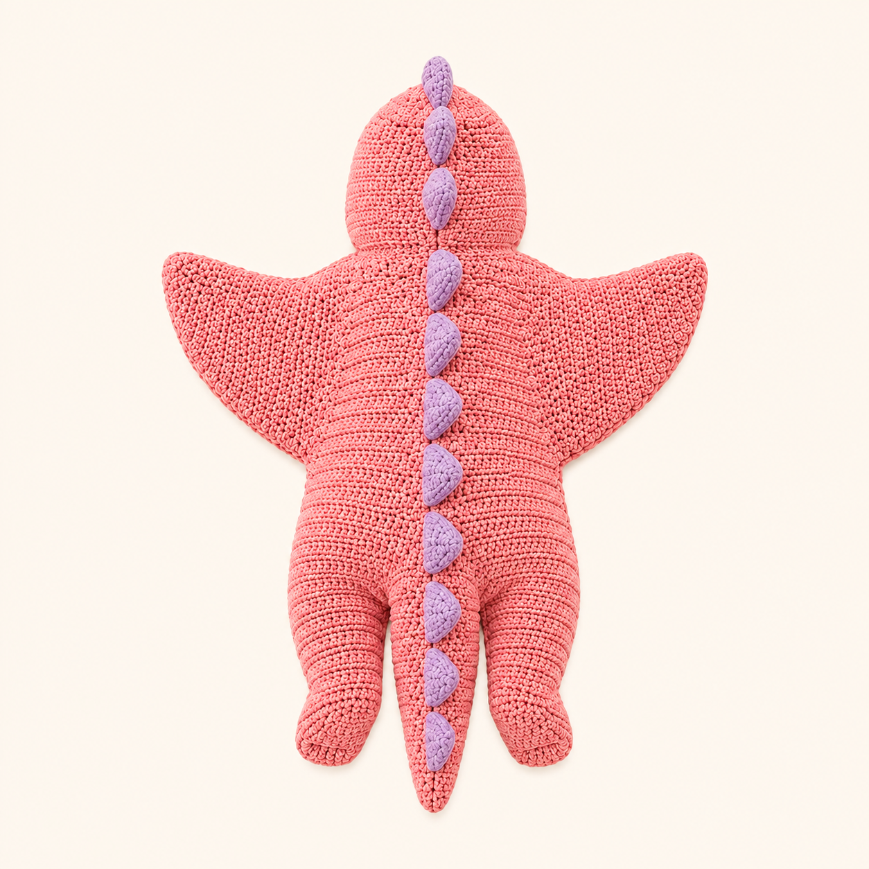 Handmade baby dinosaur costume laid flat, star-shaped crochet design